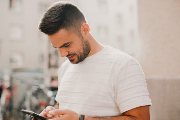 man looking at cell phone