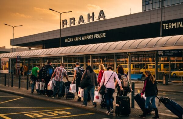 flight passengers heading into an airport in Prague