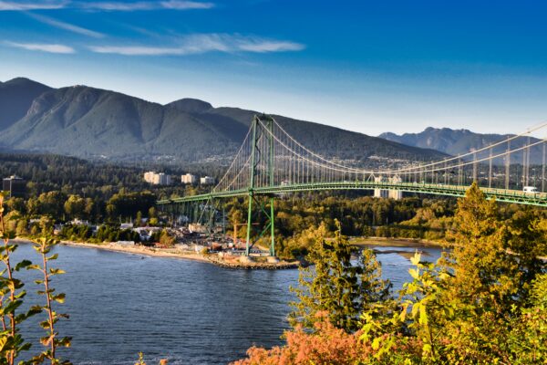 suspension bridge over the vast ocean with mountains in the distance during the fall in Vancouver, Canada