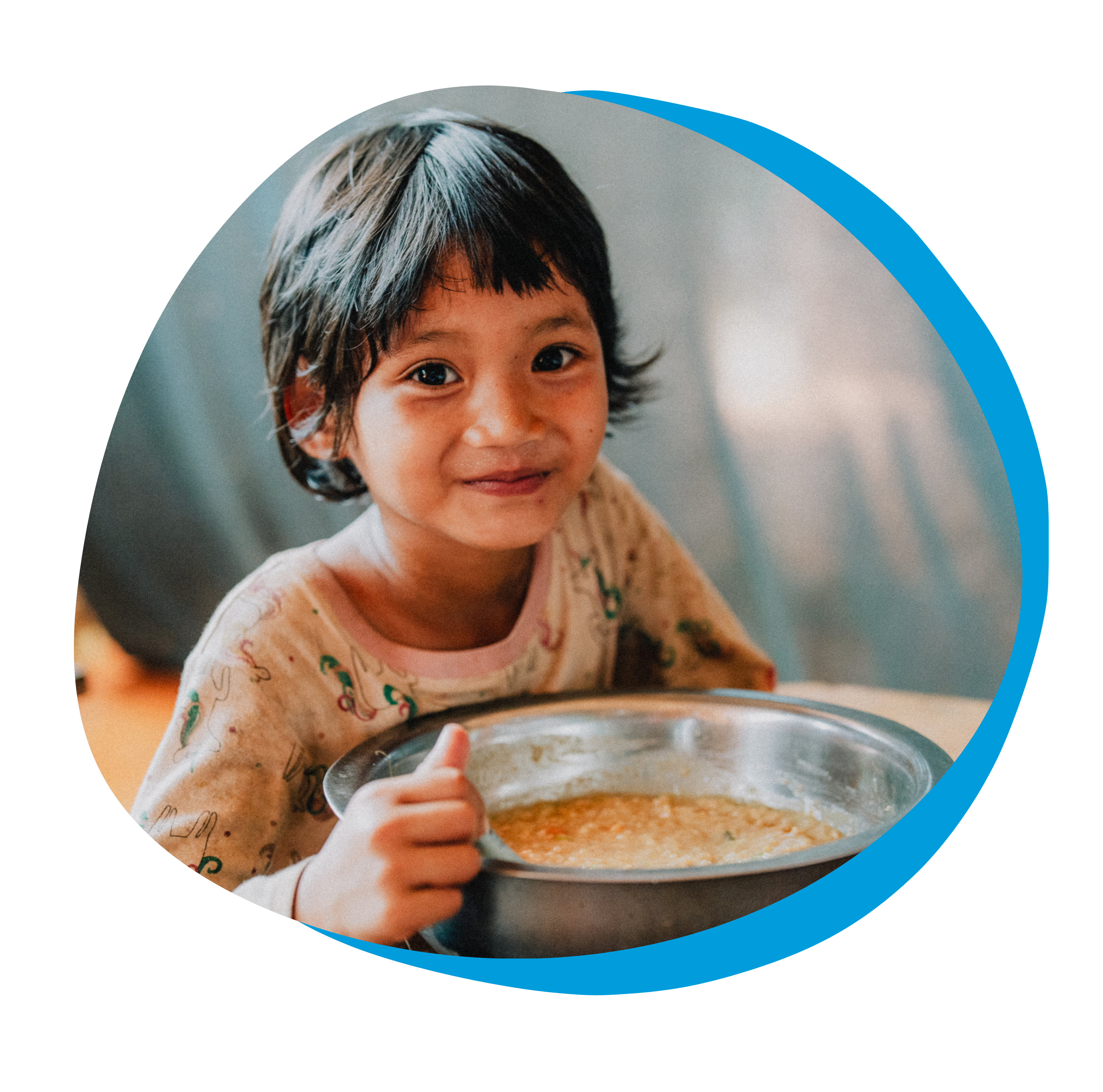 a refugee child eating a bowl of food