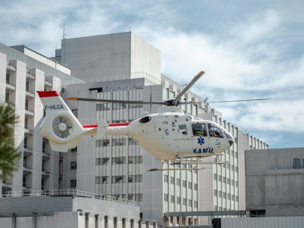 medical helicopter flying next to building