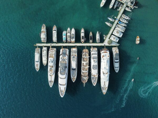 top down image of marina with large yachts lined up down the dock