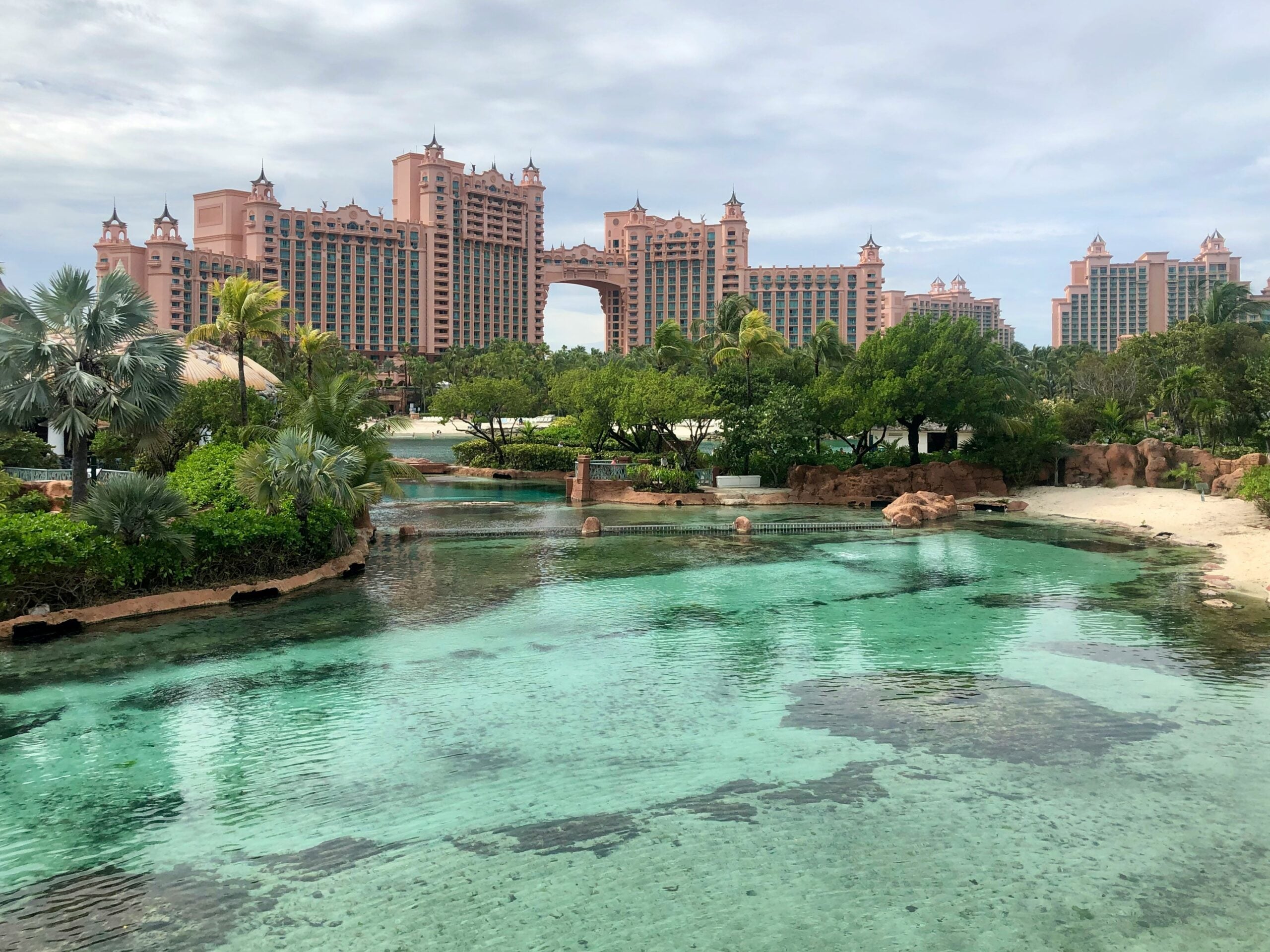 bahamas atlantis resort in the background with blue-green water in front