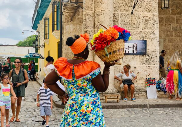 woman in cuba selling flowers in a plaza in Havana