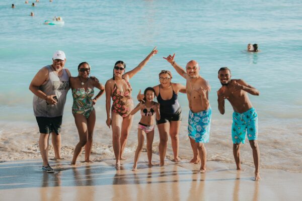 a family group posing for a picture in swimsuits on a beach