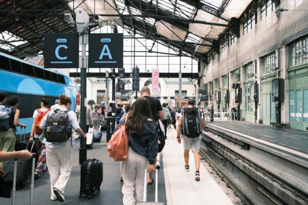 indoor train station in Europe with passengers at terminal