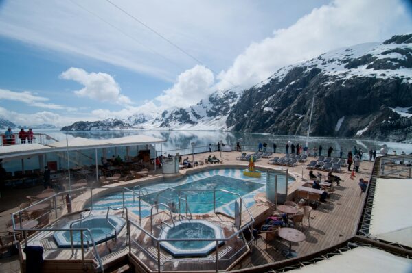 pool deck of an alaskan cruise next to snow capped mountains