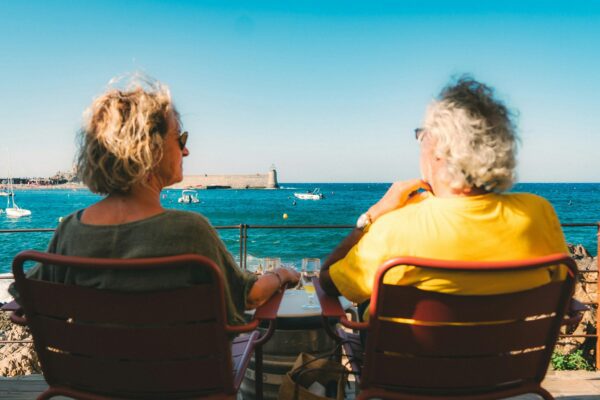 a retired couple sitting next to the sea in France